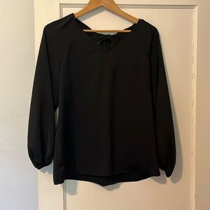 Beautiful black blouse with bow tie back detail. Worn once